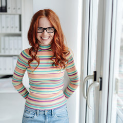 Casual happy young businesswoman in the office