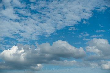 White and black clouds on a bright blue sky