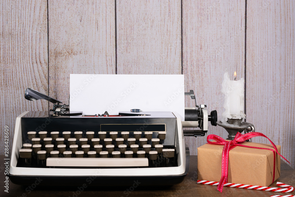 Poster retro typewriter with a blank sheet of paper for text. white new year and christmas background mock 