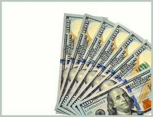 Seven one hundred dollar bills fanned out on an off white background, United States currency,...