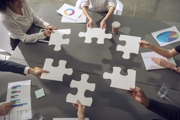 Teamwork of partners. Concept of integration and startup with puzzle pieces