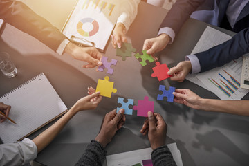 Teamwork of partners. Concept of integration and startup with puzzle pieces