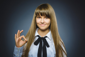 Closeup Portrait of handsome teen show Ok isolate on grey background