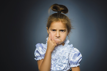Closeup Thoughtful girl with Hand at head isolated on Gray