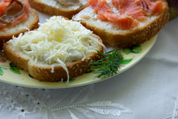 three sandwiches with red fish, one with cheese. snack