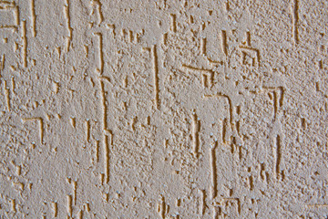 liquid plaster coating bark beetle with pieces of granite on the wall