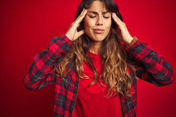 Young beautiful woman wearing casual jacket standing over red isolated background very happy and excited doing winner gesture with arms raised, smiling and screaming for success. Celebration concept.