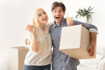Young Spouses Showing New House Keys Hugging In Own Apartment