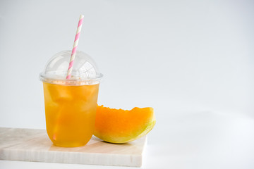Fruit tea cups. Iced tea melon on rustic white marble table. 