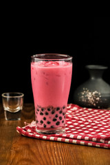 Bubble milk tea with milk  and bubble topping for tea or other beverage on the wood table with copy-space for text.