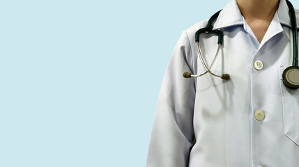 Professional doctor with stethoscope over neck isolated on blue background with clear copy space ready for diagnosis, treatment and education for patient.  Medical article and technology concept