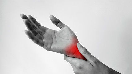 Hand anatomy with red highlight on wrist pain. Wrist pain may cause from muscle strain, tendinitis,...
