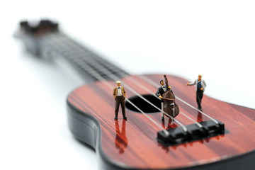 Miniature people : pianist playing piano and Violinist Man,playing musical instrument concept.