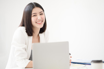 Young asian woman employee smiling with happiness and confident while looking toward camera with a white meeting room background, concept happy working environment.