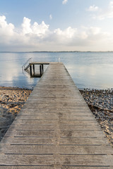 Wooden pier leading towards the ocean