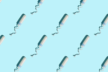 Hygiene female tampon pattern on blue background.