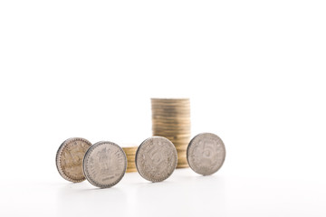 Stack of indian currency in coins  arranged as a graph on white background