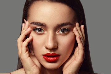 Fototapeta na wymiar Beautiful young woman with bright lipstick on grey background