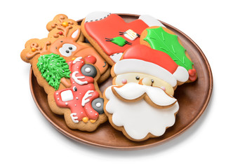 Plate with tasty Christmas cookies on white background