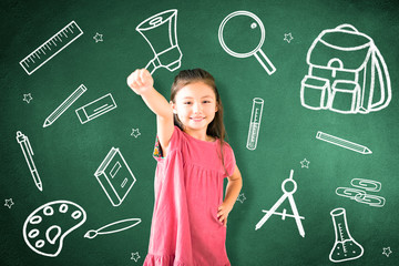 little girl standing against chalkboard and education  concept