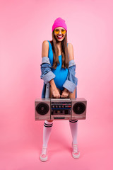 Vertical full length body size view of her she nice-looking attractive lovely shine winsome glamorous girlish cheerful straight-haired girl carrying boombox isolated over pink pastel background © deagreez