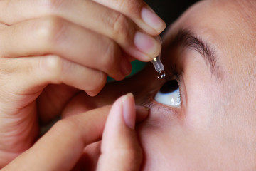 Girl dripping cleaner water for clear eyes 