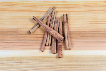Top view of dried cinnamon sticks on the wooden surface