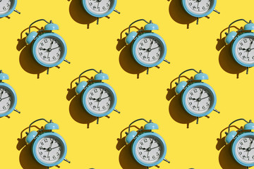 Blue alarm clock pattern on yellow background.