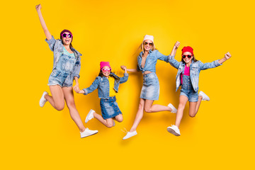 Full length photo of four charming active inspired dreamy excited optimistic small trendy carefree teenager and mom having fun time wearing denim outfit isolated yellow background