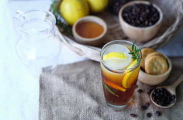 Americano iced coffee with lemon and rosemary for healthy drinking 