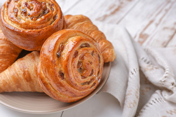 Plate with sweet pastry on table