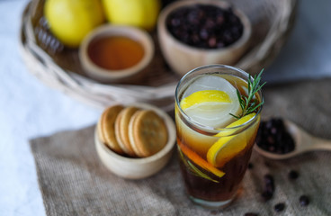 Americano iced coffee with lemon and rosemary for healthy drinking 