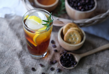 Americano iced coffee with lemon and rosemary for healthy drinking 