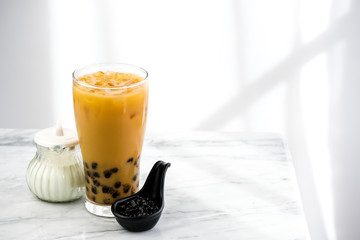 Bubble milk tea with milk  and bubble topping for tea or other beverage on the wood table with...