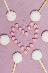 Marshmallows on pink background. Colorful marshmallow sweets with copy space