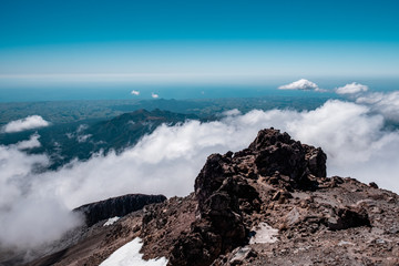 The view above the clouds and forest from a high mountain.