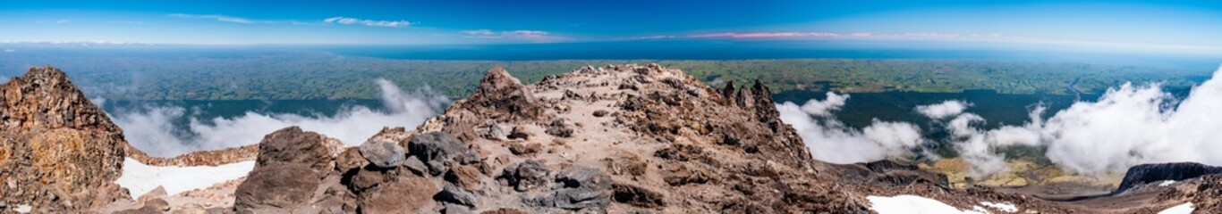 The view above the clouds and forest from a high mountain.