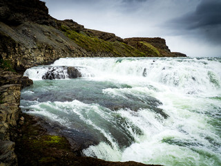 Gullfoss waterfall with dark clouds in Iceland