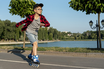Boy with blue roller blades in park