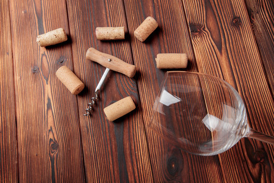 Corkscrew with cork. On a wooden background. - Image