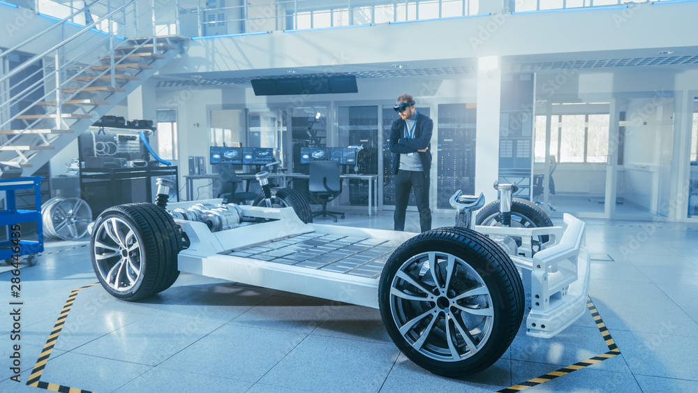 Aufkleber automotive engineer working on electric car chassis platform, using augmented reality headset. in in
