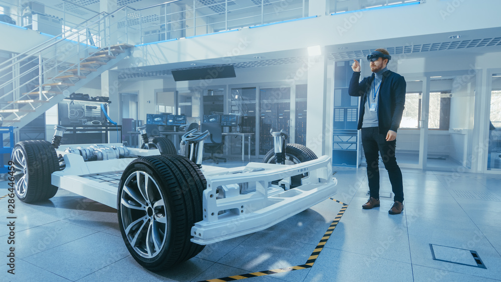 Poster automotive engineer working on electric car chassis platform, using augmented reality headset. in in