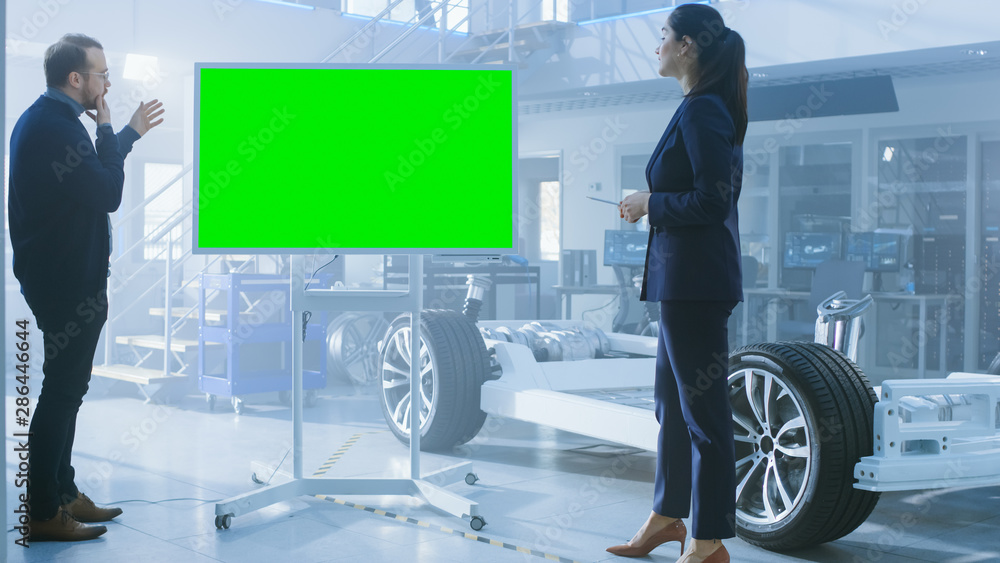 Aufkleber male and female design engineers are discussing something on a interactive whiteboard with green scr