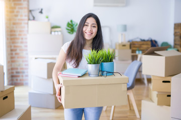 Fototapeta na wymiar Young beautiful woman moving cardboard boxes at new home