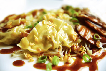 Wonton or dumpling with BBQ pork and BBQ red sauce.