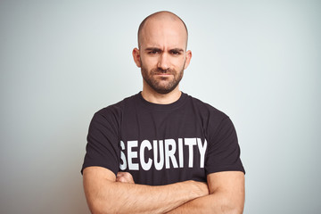Young safeguard man wearing security uniform over isolated background skeptic and nervous,...