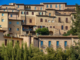 Fototapeta na wymiar Old houses in Assisi, Italy. Narrow streets of historic town in Umbria, Italy.