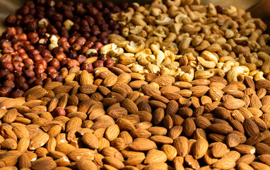 Nuts baked - almond, cashew, hazelnut in sun light, top view, healthy diet