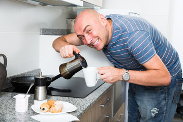 European guy pours coffee into cup of coffee pot