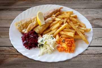 Fried fish - zander/ sander/ pikeperch, salad and french fries on plate